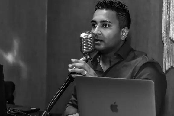 SAGE SoundWorks owner working at the microphone and sound console